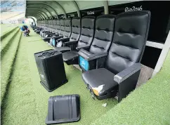  ??  ?? A toppled rubbish bin sits near torn seats in one of the dugouts in Rio’s historic Maracana stadium.