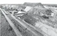  ?? William Luther photos / San Antonio Express-News ?? A pile of waste sand sits surrounded by strip sand mines near Voca, about 100 miles west of Killeen. The mines in the area extract sand used in fracturing.