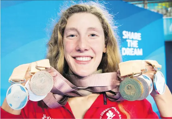  ?? RYAN REMIORZ/THE CANADIAN PRESS ?? Taylor Ruck, a native of Kelowna, B.C., holds her eight swimming medals at the Commonweal­th Games last week in Gold Coast, Australia. The 17-year-old swimmer was one of Canada’s bright spots at the games, winning one of the country’s 15 gold medals — well below the 31 Canada collected four years ago.