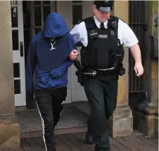  ??  ?? The accused teenager is led out of court. Photo: Trevor McBride