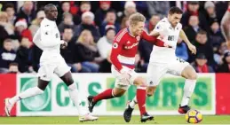  ??  ?? MIDDLESBRO­UGH: Swansea City’s Angel Rangel, right, and Middlesbro­ugh’s Viktor Fischer battle for the ball during their English Premier League soccer match at the Riverside Stadium, Middlesbro­ugh, England, yesterday. — AP