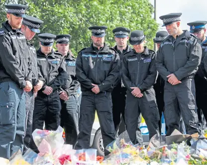  ??  ?? Police officers gather to pay their respects at the scene near Ufton Lane, Sulhamstea­d, Berkshire.