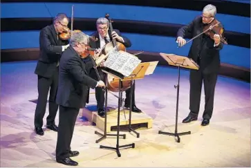  ?? Photograph­s by Barbara Davidson Los Angeles Times ?? THE EMERSON STRING QUARTET was fully engaged during the show at Walt Disney Concert Hall.