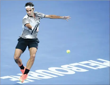  ?? Picture: EPA, LYNN BO BO ?? FANCY, COLOURFUL FOOTWORK: Roger Federer gracefully returns a forehand en route to his sixth Australian Open final yesterday.