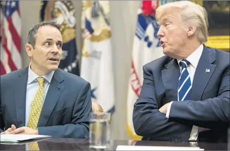  ?? Carolyn Kaster Associated Press ?? KENTUCKY Gov. Matt Bevin, with President Trump, made his state the first to win administra­tion approval for the work requiremen­t.