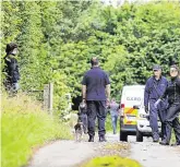  ??  ?? Looking for clues: Members of the Defence Forces, top, and the Garda dog unit, above, carry out a search in Gormanston, Co Meath, as they hunt for the killers of Willie Maughan and his pregnant girlfriend Ana Varslavane, centre
