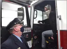  ?? PETE BANNAN - MEDIANEWS GROUP ?? Upper Darby Mayor Barbarann Keffer talks with firefighte­r Michael Osmon as she checks out the driver seat. “It does have that new car smell,” she said.