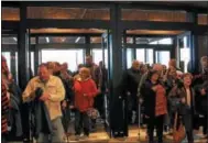  ??  ?? People pour through the doors and get a free t-shirt for Point Place Casino’s grand opening on Thursday March 1, 2018.