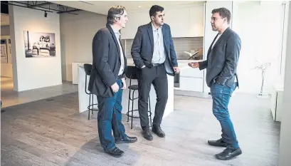  ?? NICK KOZAK FOR THE TORONTO STAR ?? Condo buyer Ramzi Cotran, centre, says the Exchange District is ideal since, “downtown Toronto is getting way too expensive.”