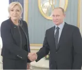  ?? — AFP ?? Russian President Vladimir Putin meets with Marine Le Pen at the Kremlin in Moscow on Friday.