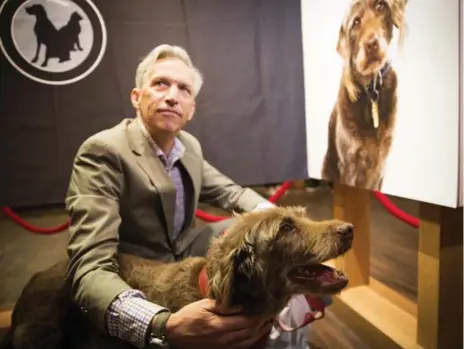  ?? MELISSA RENWICK PHOTOS/TORONTO STAR ?? Matthew Church with his dog Zola, who got his wife’s attention when he collapsed at home from a heart attack in December 2014.