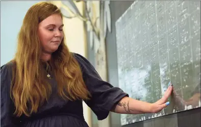  ?? Erik Trautmann / Hearst Connecticu­t Media ?? Julia Pyrlik finds the name of victim Christine Hansen on the 9/11 Memorial at Sherwood Island State Park in Westport on Thursday.