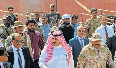  ?? Picture: AFP/ SALEH AL-OBEIDI ?? PEACE EFFORTS: Saudi ambassador to Yemen Mohammed Said Al-Jaber, centre, arrives in the southern Yemeni port of Aden to oversee an aid delivery of fuel from Saudi Arabia. The US wants an end to hostilitie­s in the region.