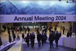  ?? (AP/Markus Schreiber) ?? Participan­ts walk through congress centre of the Annual Meeting of World Economic Forum in Davos, Switzerlan­d, on Wednesday.