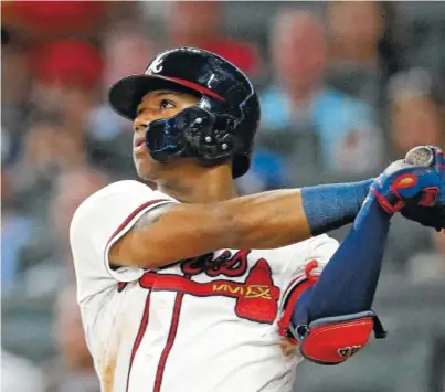  ?? AP PHOTO/JOHN BAZEMORE ?? Atlanta Braves left fielder Ronald Acuna Jr. hits a triple against the Washington Nationals during a game in Atlanta last season. Acuna helped the surprising Braves win the National League East. The Braves begin their last spring training at the Disney complex in Kissimmee, Florida, this week.