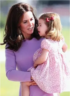  ??  ?? Nearly time to go home: Kate calms her daughter