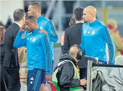  ??  ?? Patrice Evra, left, leaves the pitch after kicking a Marseille supporter at Guimaraes in Portugal.