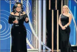  ?? REUTERS ?? Oprah Winfrey speaks after accepting the Cecil B Demille Award at the 75th Golden Globe Awards in Beverly Hills, California, on Sunday, as actor Reese Witherspoo­n looks on.