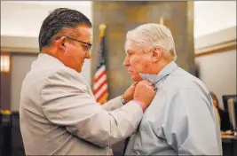  ?? Morgan Lieberman ?? Las Vegas Review-journal Attorney Clark Patrick helps Thomas Randolph with his tie before trial on Wednesday at the Regional Justice Center.