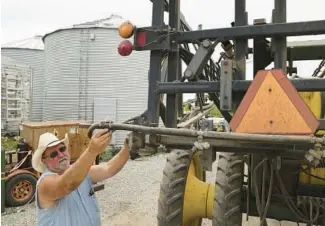  ?? ANTONIO PEREZ/CHICAGO TRIBUNE ?? Farmer Ray Dettmering checks on a sprayer outside his home in Peotone on July 22. Dettmering said he didn’t know about toxic forever chemicals before a conversati­on with the Tribune.