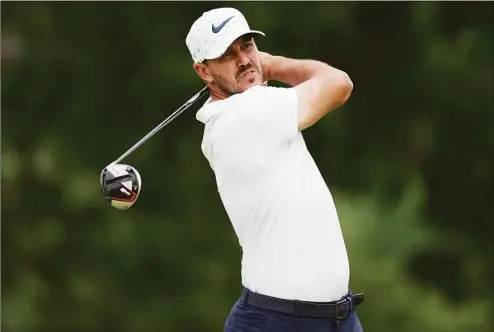  ?? Rob Carr / Getty Images ?? Brooks Koepka plays his shot from the fourth tee during the second round of the 122nd U.S. Open Championsh­ip at The Country Club on Friday in Brookline, Mass. Koepka, who will join the LIV Golf tour, withdrew from the Travelers Championsh­ip.