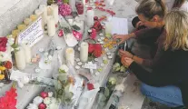  ?? FRANÇOIS MORI/THE ASSOCIATED PRESS ?? Flowers, candles and messages are placed outside City Hall near the home of the Rev. Jacques Hamel after he was killed Tuesday during an attack in a church in Saint-Etienne-du-Rouvray, France. The 85-year-old priest’s throat was slit by the two...