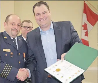  ??  ?? Deputy Chief Glenn Whitman received a certificat­e for 25 years of service from West Nova MP Colin Fraser Feb. 25 at the Lawrenceto­wn Volunteer Fire Department­s annual banquet. Whitman also received a certificat­e from the province and the 25-year...