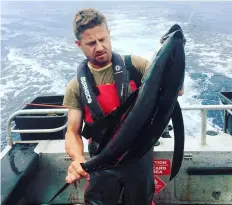  ??  ?? Above: Scott McNeil, of artisan fishing and wild-food company Awatoru, with a tuna caught off the Kāpiti Coast.