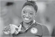  ?? Rebecca Blackwell / Associated Press ?? Simone Biles was a picture of poise and grace in winning four gold medals and one bronze.