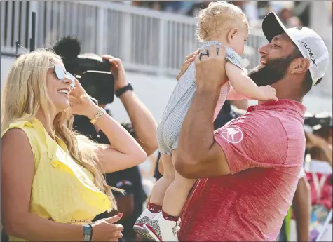  ?? HECTOR VIVAS/GETTY IMAGES ?? Jon Rahm greets his wife Kelley Cahill and their son Kepa after the Spanish golfer won the Mexico Open at Vidanta 2022 on Sunday in Puerto Vallarta.
