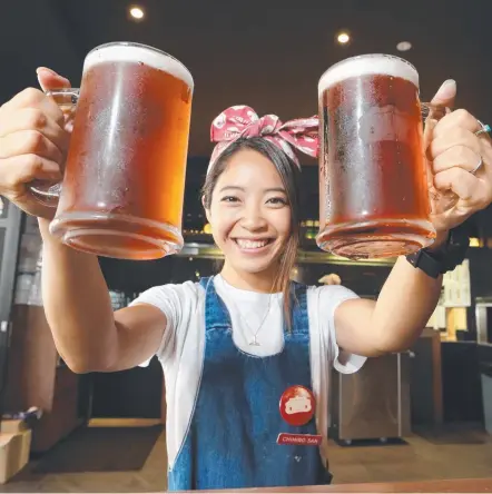  ?? Picture: GLENN HAMPSON ?? Staff member Chihiro Terao with Harajuku Gyoza's new Pink Dragon Fruit beer.