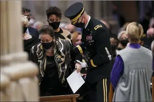  ?? ANDREW HARNIK - THE ASSOCIATED PRESS ?? Alma Powell, is escorted to her seat by U.S. Army Major Gen. Allan Pepin, commanding officer of the Joint Force Headquarte­rs National Capitol Region, before the funeral for former Secretary of State Colin Powell at the Washington National Cathedral, in Washington, Friday.