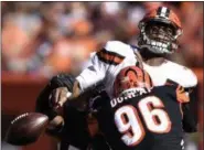  ?? DAVID RICHARD —ASSOCIATED PRESS ?? Browns quarterbac­k DeShone Kizer, top, loses control of the ball under pressure from Bengals defensive end Carlos Dunlap on Oct. 1.