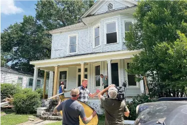  ?? Associated Press ?? ■ "This Old House" host Kevin O'connor prepares to install the front door in Atlanta on Aug. 10. A five-bedroom Victorian house south of Georgia’s capitol was in severe disrepair until an Atlanta couple saw its potential. Then they learned it was built around 1900 by South Atlanta postmaster and civil rights activist Luther Judson Price. The PBS home improvemen­t show “This Old House” will stream episodes on their renovation in September.