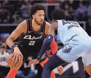  ?? RICK OSENTOSKI/USA TODAY SPORTS ?? Pistons guard Cade Cunningham dribbles defended by Grizzlies forward GG Jackson in the Pistons’ 110-108 loss Monday at Little Caesars Arena.