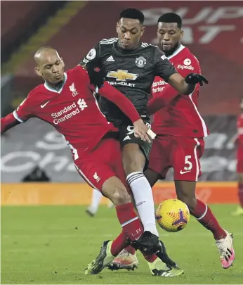  ?? AP ?? Anthony Martial is denied by Fabinho, left, who played as a makeshift central defender