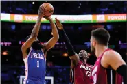  ?? MATT SLOCUM — THE ASSOCIATED PRESS ?? Sixers guard James Harden, left, goes up for a shot against the Miami Heat’s Bam Adebayo during the second half of Game 3 Friday night at Wells Fargo Center. The 76ers won 99-79.