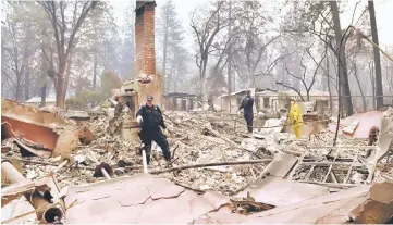  ??  ?? Alameda County Sheriff Coroner officers search for human remains at a burned residence in Paradise, California.