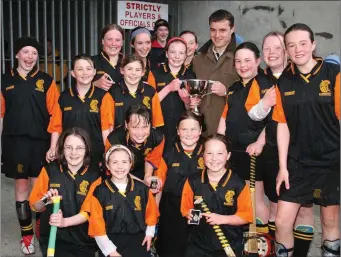  ??  ?? Ciara Lawler, the Rathnure captain, receives the Rackard League camogie trophy from Seamus Kavanagh.