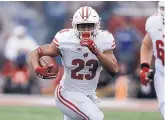  ?? DARRIN CUMMINGS, STAFF ?? Wisconsin running back Jonathan Taylor will lead the unbeaten Badgers as they host the fourthrank­ed Michigan defense today.