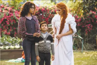  ?? Atsushi Nishijima / Disney ?? Meg (Storm Reid, left) and her brother Charles (Deric McCabe) look for their scientist father with help from Mrs. Whatsit (Reese Witherspoo­n) in “A Wrinkle in Time.”