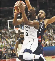  ?? Ye Aung Thu / AFP / Getty Images ?? The US’s Kemba Walker, left, takes a shot as France’s Nicolas Batum defends during the World Cup quarterfin­als on Wednesday.