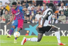  ?? AFP ?? Barcelona’s Ansu Fati, left, scores against Velancia in La Liga on Sunday.