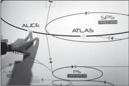  ??  ?? THE ASSOCIATED PRESS In this May 2011 photo, a physicist shows a diagram of what the long-presumed Higgs boson particle is thought to look like.