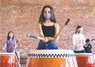  ?? Photos by Jessica Christian / The Chronicle ?? Lucia Villanueva, 9, practices in the Taiko drumming class that’s part of an arts pod organized by Dance Mission Theater. Many children are happily participat­ing in pandemicti­me pods — but not all.