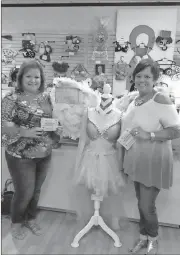  ?? Contribute­d by Holmes for Her ?? Congratula­tions are offered up to first place winner Penny Bevis (left) who raised $329 with her votes in the first ever Bra for a Cause competitio­n. Third place went to Cindy Easterwood, who raised $214.