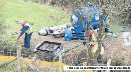  ??  ?? &gt; The clean-up operation after the oil spill at Cross Hands