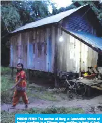  ??  ?? PHNOM PENH: The mother of Nary, a Cambodian victim of forced marriage to a Chinese man, walking in front of their home in Phnom Penh.