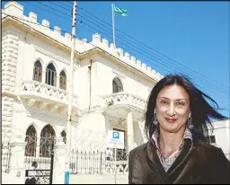  ??  ?? Maltese investigat­ive journalist Daphne Caruana Galizia poses outside the Libyan embassy in Valletta in a photo dated April 6, 2011.