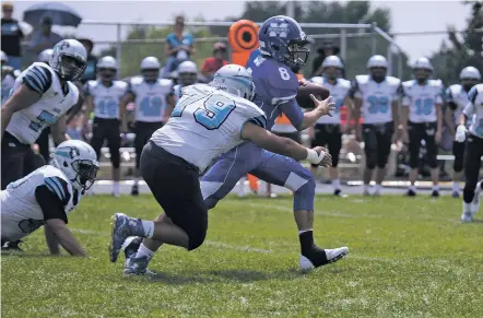  ?? PHOTOS BY JASON STILGEBOUE­R/FOR THE NEW MEXICAN ?? Cesar Granados of Capital High School attempts to tackle St. Michael’s Antonio Gabaldon during Saturday’s game. Gabaldon threw for 317 yards and six touchdowns to lead St. Michael’s to a 46-27 win over the Jaguars.